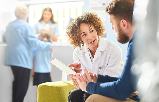 woman pharmacist speaking to member about prescription