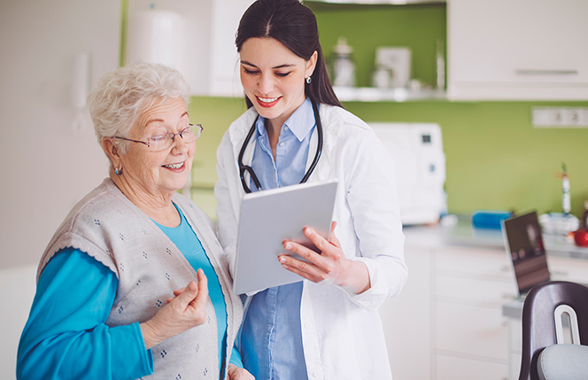 doctor showing patient information on tablet