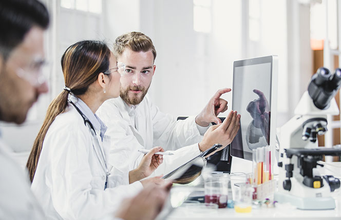 Scientists looking at computer